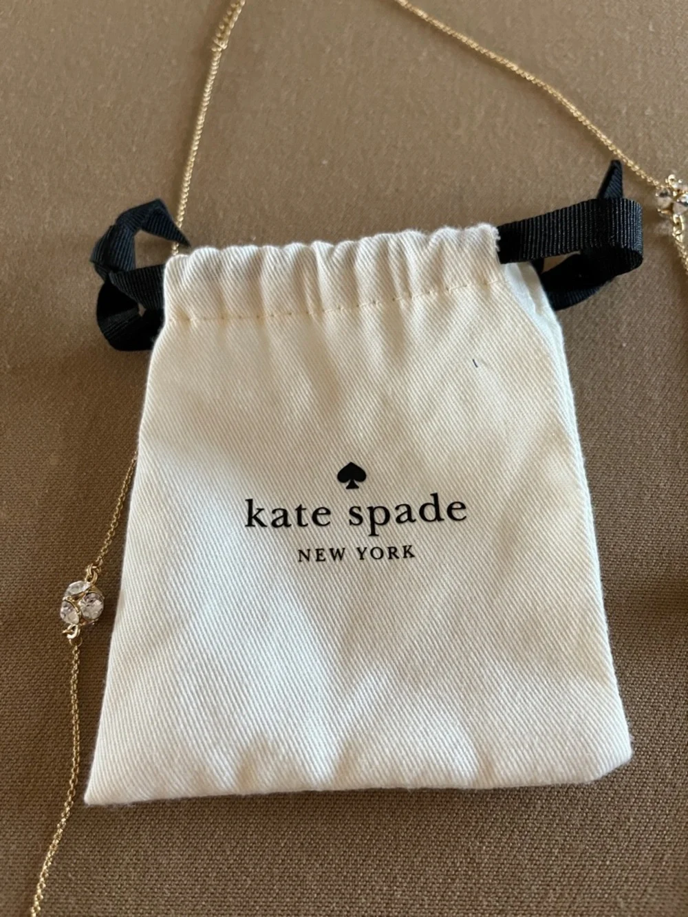 Kate Spade long golden necklace with crystal beads.